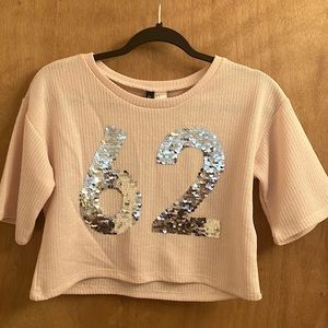 Light pink Y2K style cropped sweater with the number 62 in silver sequence
